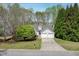 Charming home with a two-car garage, a spacious driveway, and manicured landscaping at 1545 Smoke Hill Dr, Hoschton, GA 30548
