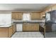 Traditional kitchen with granite countertops, tile flooring, and wooden cabinets, plus stainless steel appliances at 1545 Smoke Hill Dr, Hoschton, GA 30548