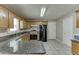 Classic kitchen boasts granite countertops, tile flooring, and wooden cabinets, alongside modern appliances at 1545 Smoke Hill Dr, Hoschton, GA 30548