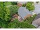 Aerial view of a home with a backyard featuring a patio, pergola, and play area, nestled among trees at 2023 Belridge Se Ct, Smyrna, GA 30080