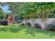 Backyard featuring a wooden playset, trampoline, landscaped garden, and white picket fence at 2023 Belridge Se Ct, Smyrna, GA 30080
