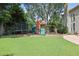 Spacious, green backyard includes a trampoline, playset, and covered patio at 2023 Belridge Se Ct, Smyrna, GA 30080