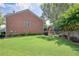 Large backyard with lush green grass, brick exterior, complemented by mature landscaping, creating a serene environment at 2023 Belridge Se Ct, Smyrna, GA 30080
