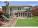 Spacious backyard with lush lawn, patio, pergola, and a fun playset at 2023 Belridge Se Ct, Smyrna, GA 30080