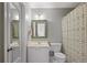 A neutral bathroom with a framed mirror over the vanity and a tub/shower combo at 2023 Belridge Se Ct, Smyrna, GA 30080