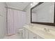 Bathroom featuring double sink vanity, framed mirror, and mermaid scale shower curtain at 2023 Belridge Se Ct, Smyrna, GA 30080
