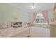 Bright bedroom with soft pastel walls, a ceiling fan, a desk, and a comfortable, flower-patterned bed at 2023 Belridge Se Ct, Smyrna, GA 30080