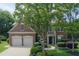 Charming brick home with two-car garage, manicured front yard, and mature trees offering shade at 2023 Belridge Se Ct, Smyrna, GA 30080