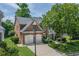 Beautiful brick home with a manicured front lawn, two-car garage, and charming balcony detail at 2023 Belridge Se Ct, Smyrna, GA 30080