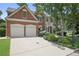 Stately brick home boasts a two-car garage, pristine landscaping, and a spacious driveway at 2023 Belridge Se Ct, Smyrna, GA 30080