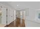 Second floor hallway with hardwood flooring, neutral paint, and access to multiple rooms at 2023 Belridge Se Ct, Smyrna, GA 30080