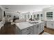 Well-lit open concept kitchen with center island, dining space, and backyard view at 2023 Belridge Se Ct, Smyrna, GA 30080