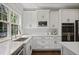 Bright kitchen boasts white cabinetry, stainless appliances, granite counters, and ample natural light at 2023 Belridge Se Ct, Smyrna, GA 30080