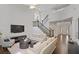 Spacious living room with wood floors, staircase, white sofas, and large windows at 2023 Belridge Se Ct, Smyrna, GA 30080