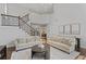 Bright living room features hardwood floors, staircase with railing, and neutral-toned sofas at 2023 Belridge Se Ct, Smyrna, GA 30080