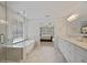 Bright main bathroom features double sinks, soaking tub and seamless glass shower at 2023 Belridge Se Ct, Smyrna, GA 30080