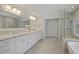 This bright bathroom features double sinks, soaking tub, and a frameless glass shower at 2023 Belridge Se Ct, Smyrna, GA 30080
