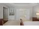 This neutral main bedroom showcases a bar area and double doors to the main bathroom at 2023 Belridge Se Ct, Smyrna, GA 30080
