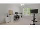 Bright office with large window, desk, computer, exercise bike, and neutral colored walls at 2023 Belridge Se Ct, Smyrna, GA 30080