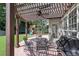 Pergola-covered patio with dining set, grill, and view of the backyard playset at 2023 Belridge Se Ct, Smyrna, GA 30080