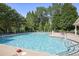 Community pool with lounge chairs and umbrellas, perfect for summer relaxation and recreation at 2023 Belridge Se Ct, Smyrna, GA 30080