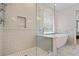 A luxurious shower features a seamless glass door, herringbone tile and rainfall shower head at 2023 Belridge Se Ct, Smyrna, GA 30080