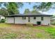 Backyard view of a house with fresh paint, a well maintained lawn, and new landscaping at 2244 Alpha Dr, Decatur, GA 30032