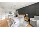 This stylish bedroom features a statement wall, a modern chandelier, and hardwood floors at 2244 Alpha Dr, Decatur, GA 30032