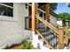 Side angle of new front steps with wood posts and metal railing, fresh paint, and updated landscaping at 2244 Alpha Dr, Decatur, GA 30032