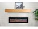 Modern fireplace with light wood mantel and shiplap accent wall at 2244 Alpha Dr, Decatur, GA 30032