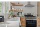 Stylish kitchen with white countertops, modern appliances, and open shelving at 2244 Alpha Dr, Decatur, GA 30032