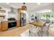 Open kitchen with stainless steel appliances and natural wood cabinets, connected to dining area at 2244 Alpha Dr, Decatur, GA 30032