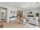 Open living room floor plan with fireplace, hardwood floors, and adjacent kitchen at 2244 Alpha Dr, Decatur, GA 30032