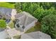 Overhead view of a home highlighting its architectural design, landscaping, and roof at 2307 Loughridge Dr, Buford, GA 30519