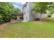 View of a lush backyard with a pergola, a seating area, and a well-maintained lawn at 2307 Loughridge Dr, Buford, GA 30519