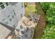 Aerial view of a patio with outdoor seating, grill, and landscaped yard at 2307 Loughridge Dr, Buford, GA 30519