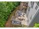 Aerial view of a backyard featuring a spacious patio, a pergola with grill, and a fire pit area for outdoor enjoyment at 2307 Loughridge Dr, Buford, GA 30519