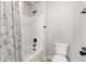 Clean white bathroom featuring a shower with a tub and a modern toilet at 2307 Loughridge Dr, Buford, GA 30519