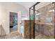 Luxurious bathroom featuring a glass-enclosed shower with stone tile and a view into the main bedroom at 2307 Loughridge Dr, Buford, GA 30519