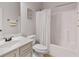Bright, functional bathroom featuring a shower-tub combination, vanity with sink, and white color palette at 2307 Loughridge Dr, Buford, GA 30519