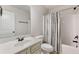 Well-lit bathroom featuring a tub with shower and a vanity with a white countertop at 2307 Loughridge Dr, Buford, GA 30519