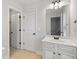 Bright bathroom with white cabinets, a large mirror, and tile floors at 2307 Loughridge Dr, Buford, GA 30519