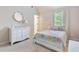 Inviting bedroom with soft colors, white dresser, and a decorative mirror above it at 2307 Loughridge Dr, Buford, GA 30519