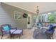 Cozy covered outdoor deck featuring comfortable seating, a TV, and a fire pit at 2307 Loughridge Dr, Buford, GA 30519