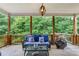 Covered outdoor deck with comfortable seating and wooded views for relaxing or entertaining at 2307 Loughridge Dr, Buford, GA 30519