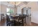Elegant dining room with a coffered ceiling, chandelier, and dark wood floors provides a welcoming space at 2307 Loughridge Dr, Buford, GA 30519