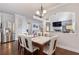 Bright dining room with hardwood floors and open-concept design to the living room at 2307 Loughridge Dr, Buford, GA 30519