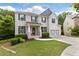 Charming two-story home with a brick facade, manicured lawn, and a two-car garage at 2307 Loughridge Dr, Buford, GA 30519