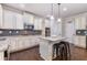Modern kitchen featuring granite countertops, stainless steel appliances, and a breakfast bar at 2307 Loughridge Dr, Buford, GA 30519