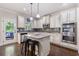Modern kitchen with white cabinets, stainless appliances, granite countertops, an island, and hardwood floors at 2307 Loughridge Dr, Buford, GA 30519